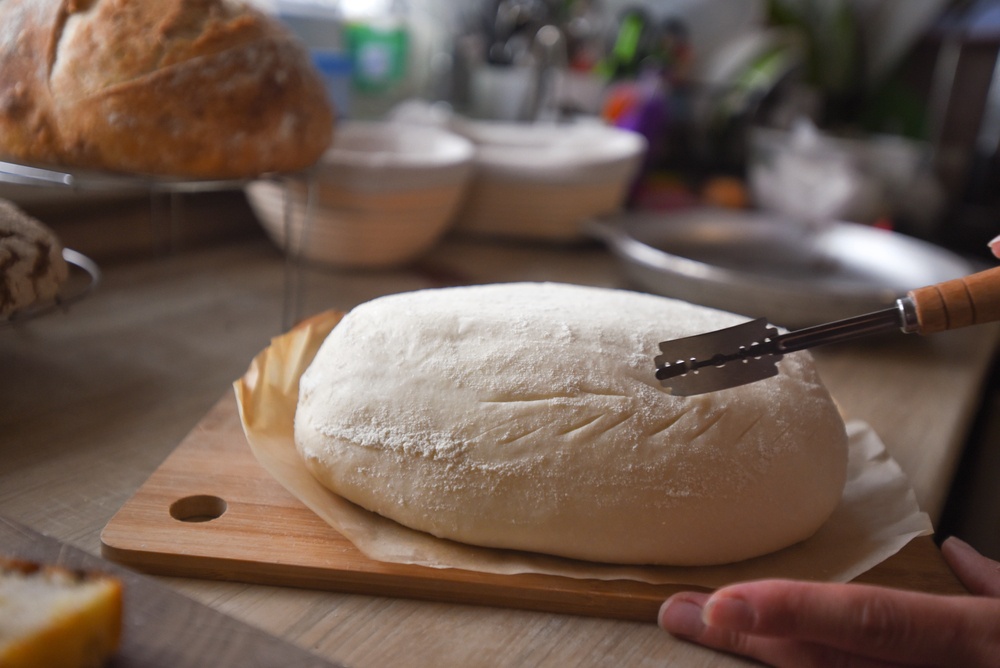 woman makes bread at home kitchen